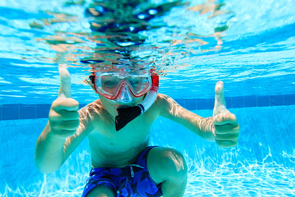 kid snorkeling in pool
